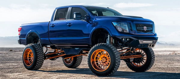 Front three-quarter blue lifted 2017 Nissan Titan copper wheels FOX shocks desert CaliCustomsOKC Conductor's Special 544K Nightmare Edition train horn kit featured customer install gallery photo 1