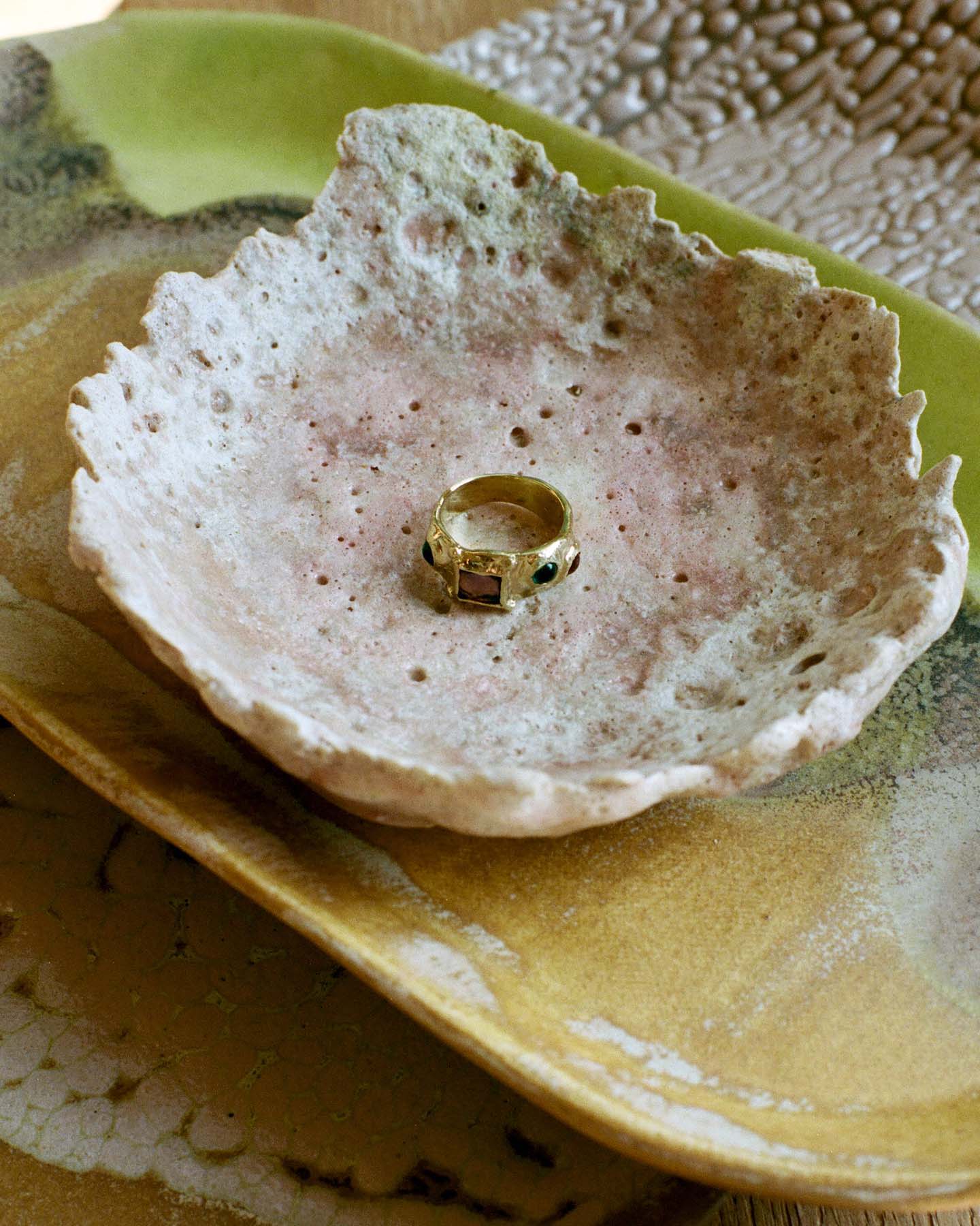 Close up of the Mondo Mondo suede ring on Raina Lee ceramics.
