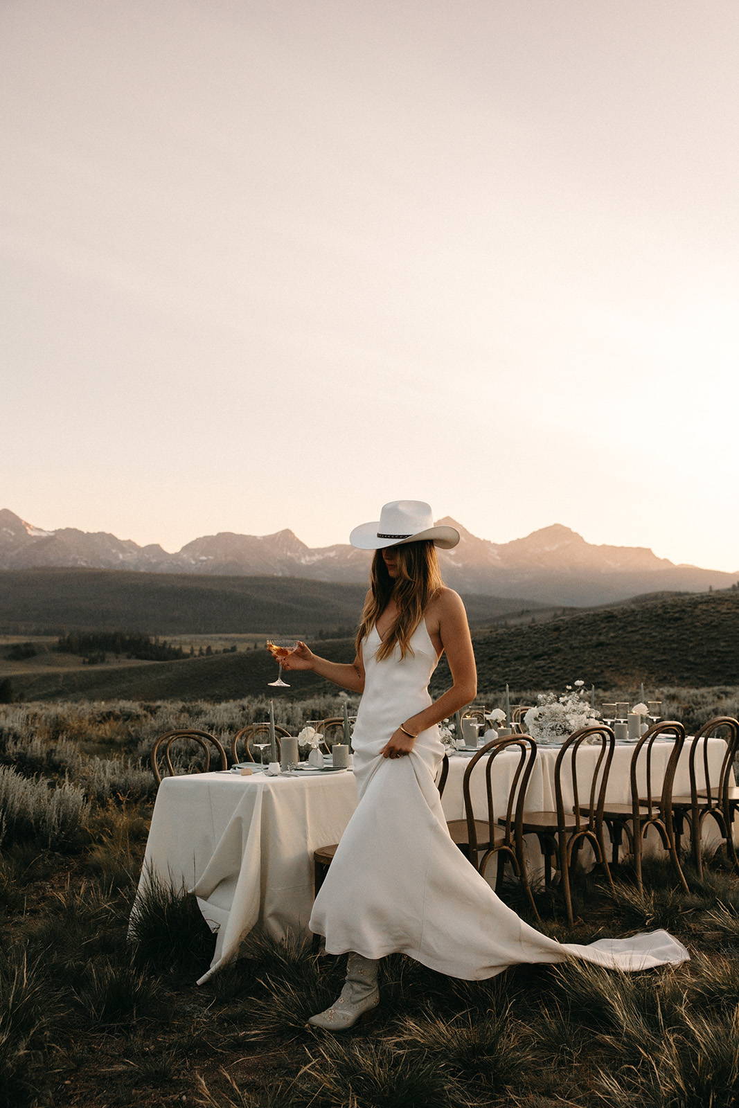 Bride in the Summer gown with a cowboy hat and boots