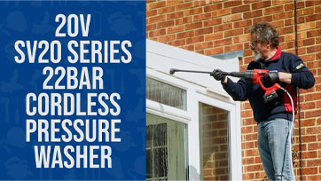 Person using a cordless pressure washer on a building exterior.