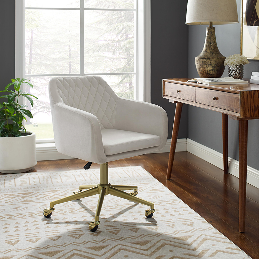 Home office setup featuring a white desk chair and wood desk near large windows.
