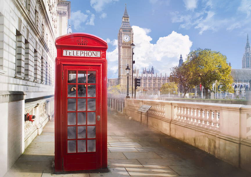 A giant smoke grey persian is hiding inside a phone-box by Big Ben and the Houses of Parliament
