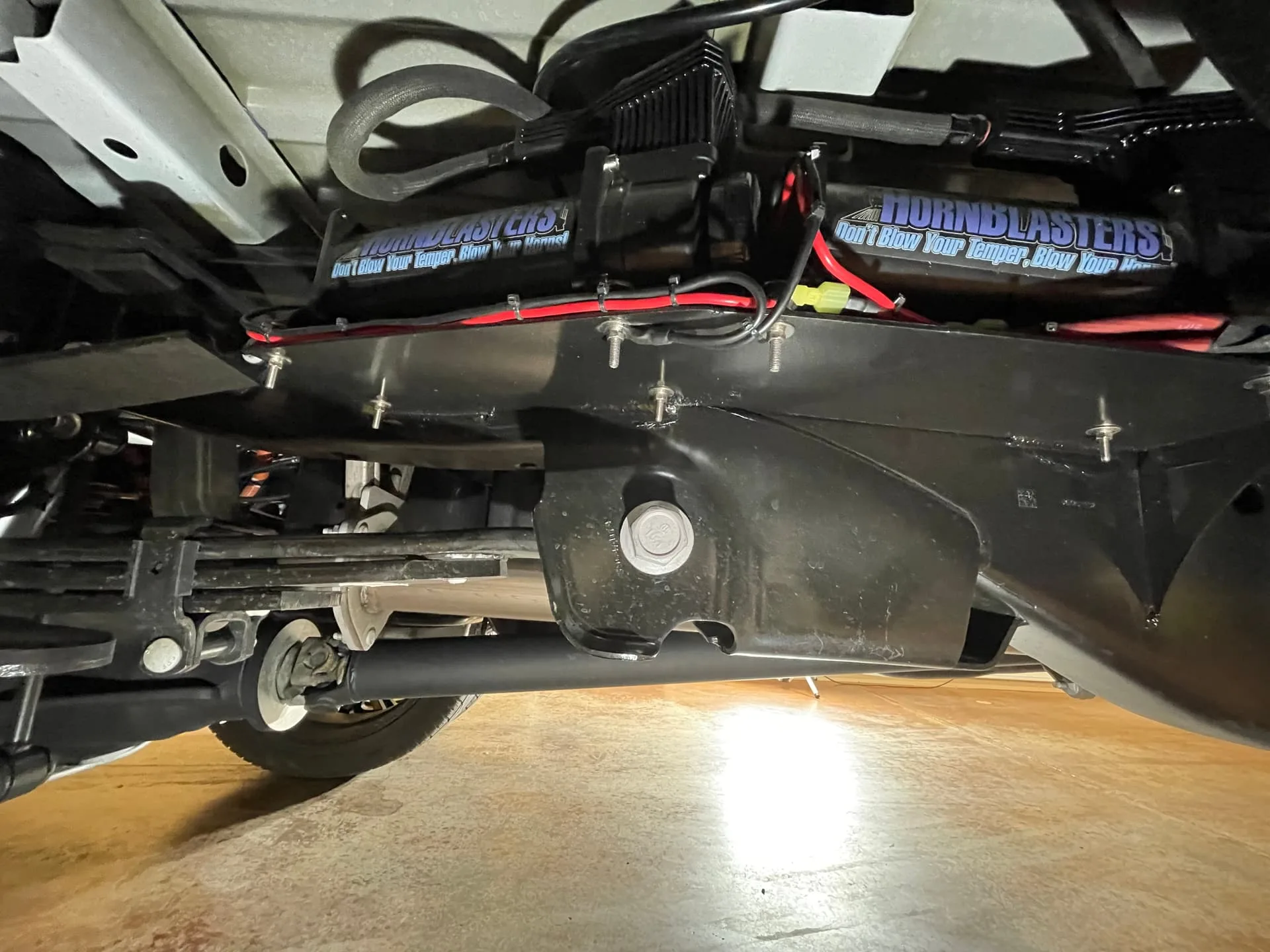 Dual HornBlasters air tanks and compressor mounted above rear axle on Robert's Ford F450 photo 6