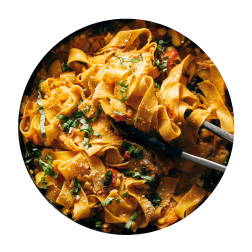 egg pappardelle pasta in a creamy light red sauce