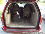 Open liftgate rear cargo black carpeted enclosure silver compressor third row removed Leonard's Caravan Grand Cargo 232 gallery photo 5