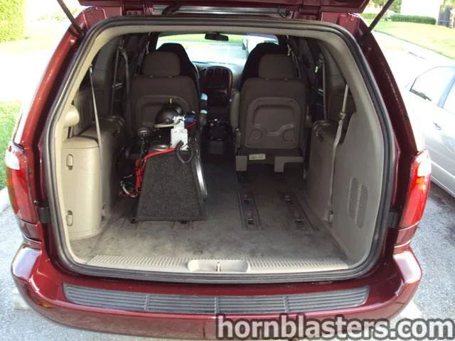 Open liftgate rear cargo black carpeted enclosure silver compressor third row removed Leonard's Caravan Grand Cargo 232 gallery photo 5