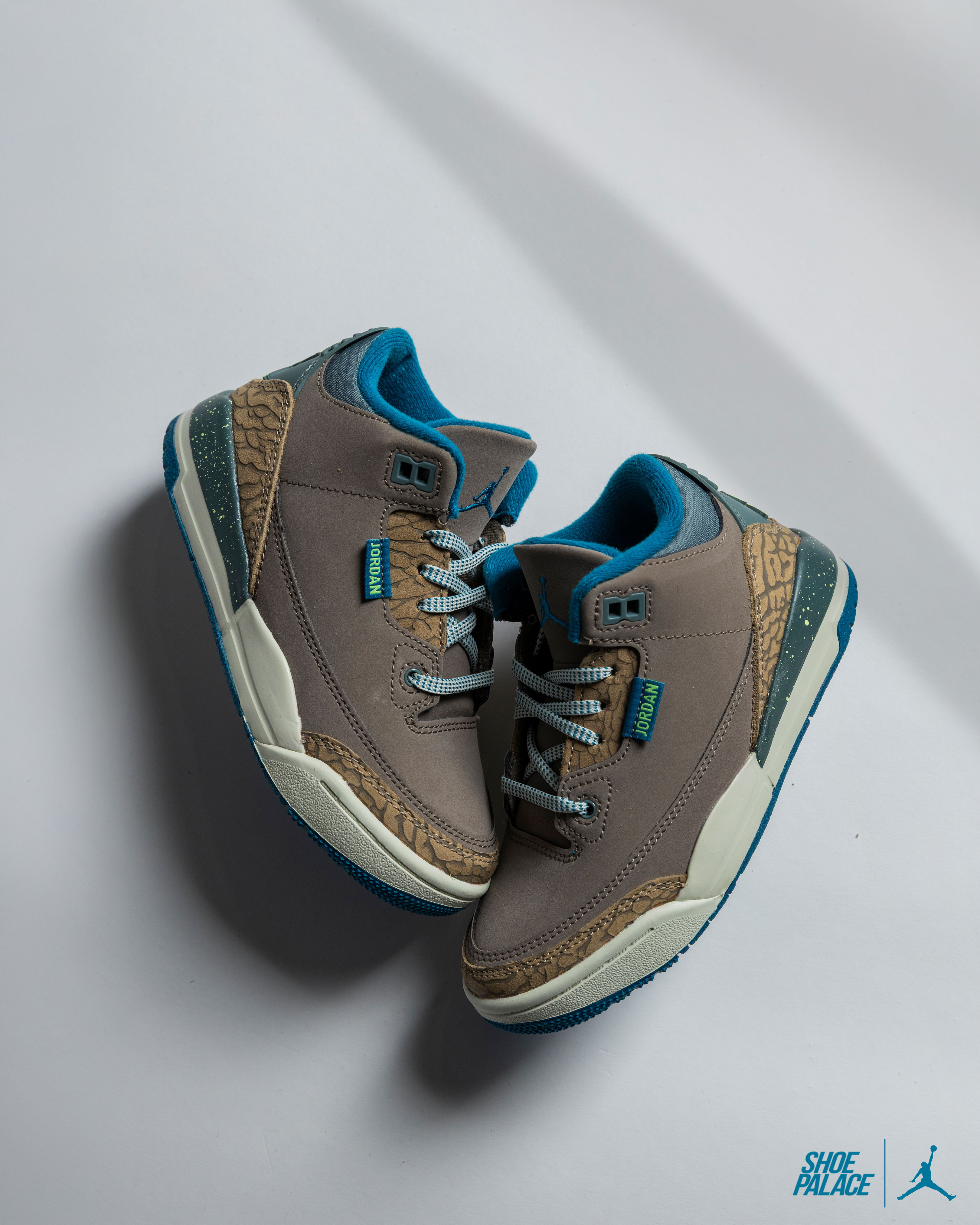 Air Jordan 3 Retro Olive Grey - A pair of gray and teal sneakers on a white background.