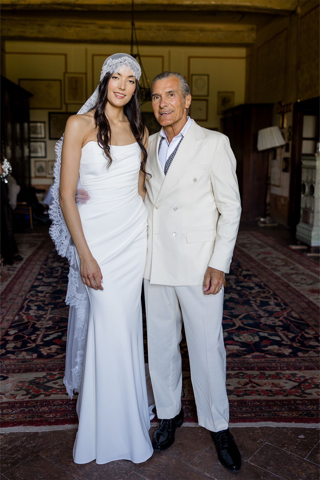 Bride and groom posing together in a decorated interior.