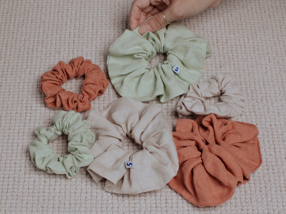 linen scrunchies of various sizes in light green, beige and terracotta