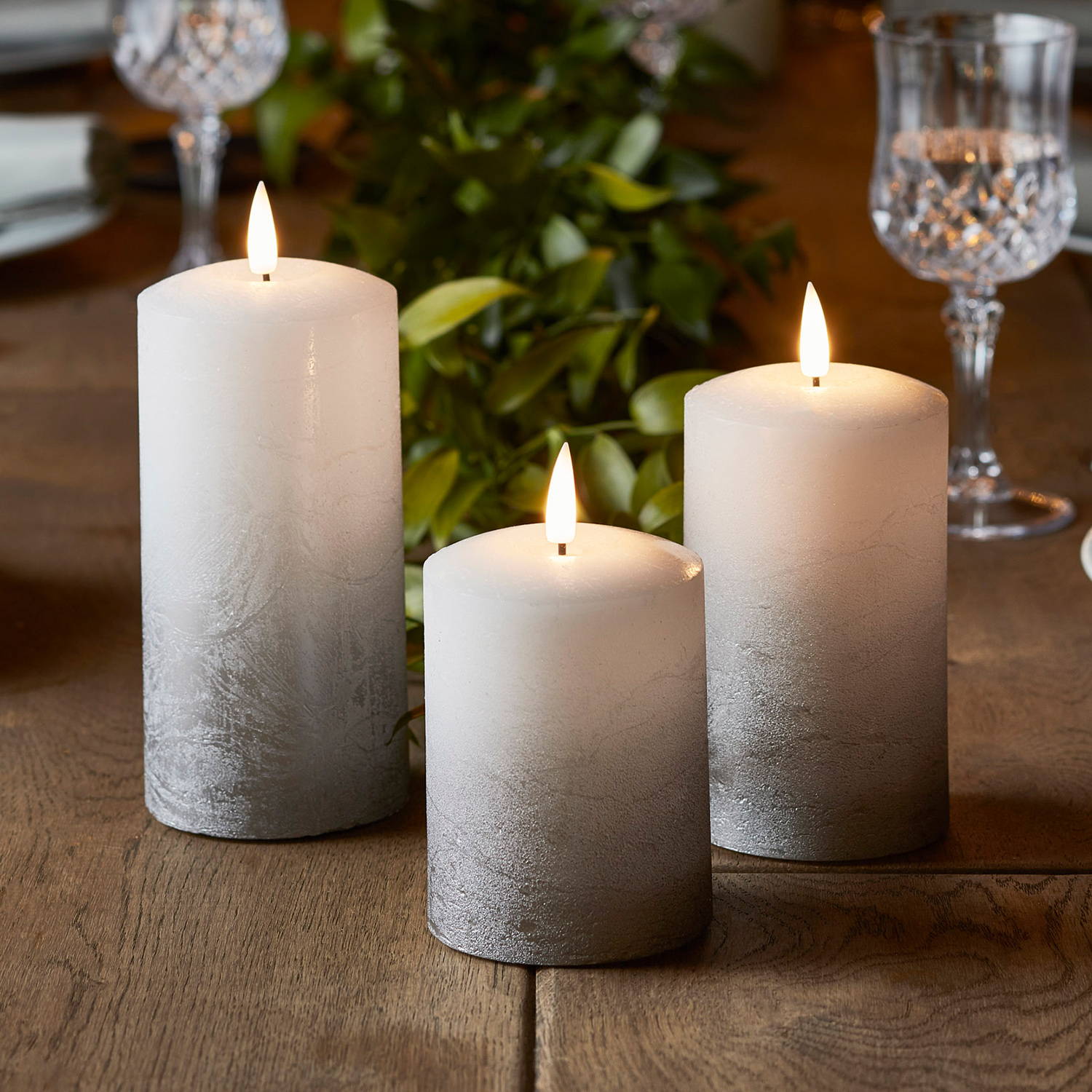 Silver ombre TruGlow candles styled on table at differing heights