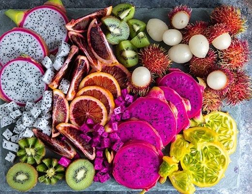 A colorful assortment of exotic fruits arranged on a platter.