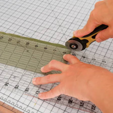 Cut 1 part of the seam allowance with a rotary cutter, ruler and cutting mat