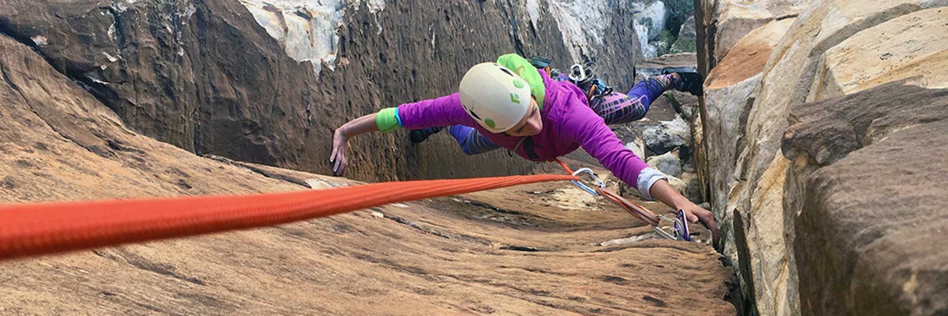 Female climber scaling walls