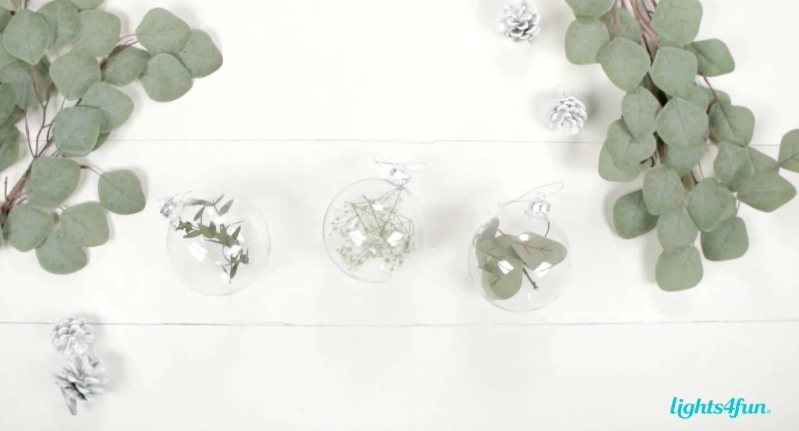 A trio of clear baubles with Scandi themed content. The end product of the DIY.