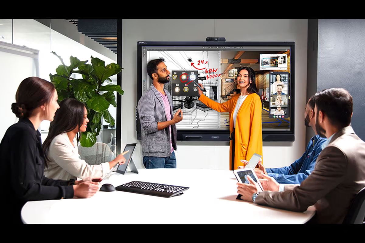 A group meeting with a presentation on a screen and engaged participants.