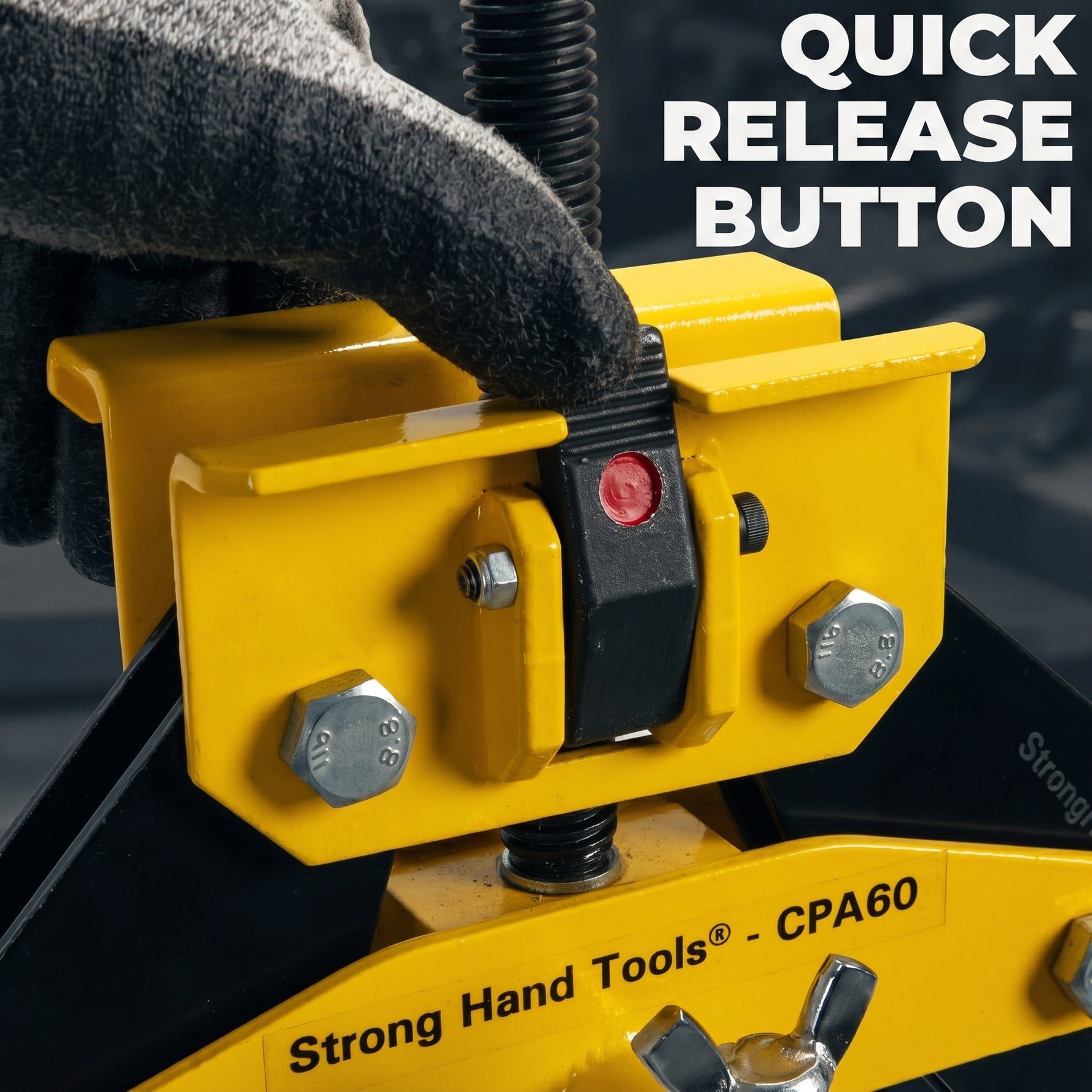 Hand pressing a quick release button on a yellow tool.