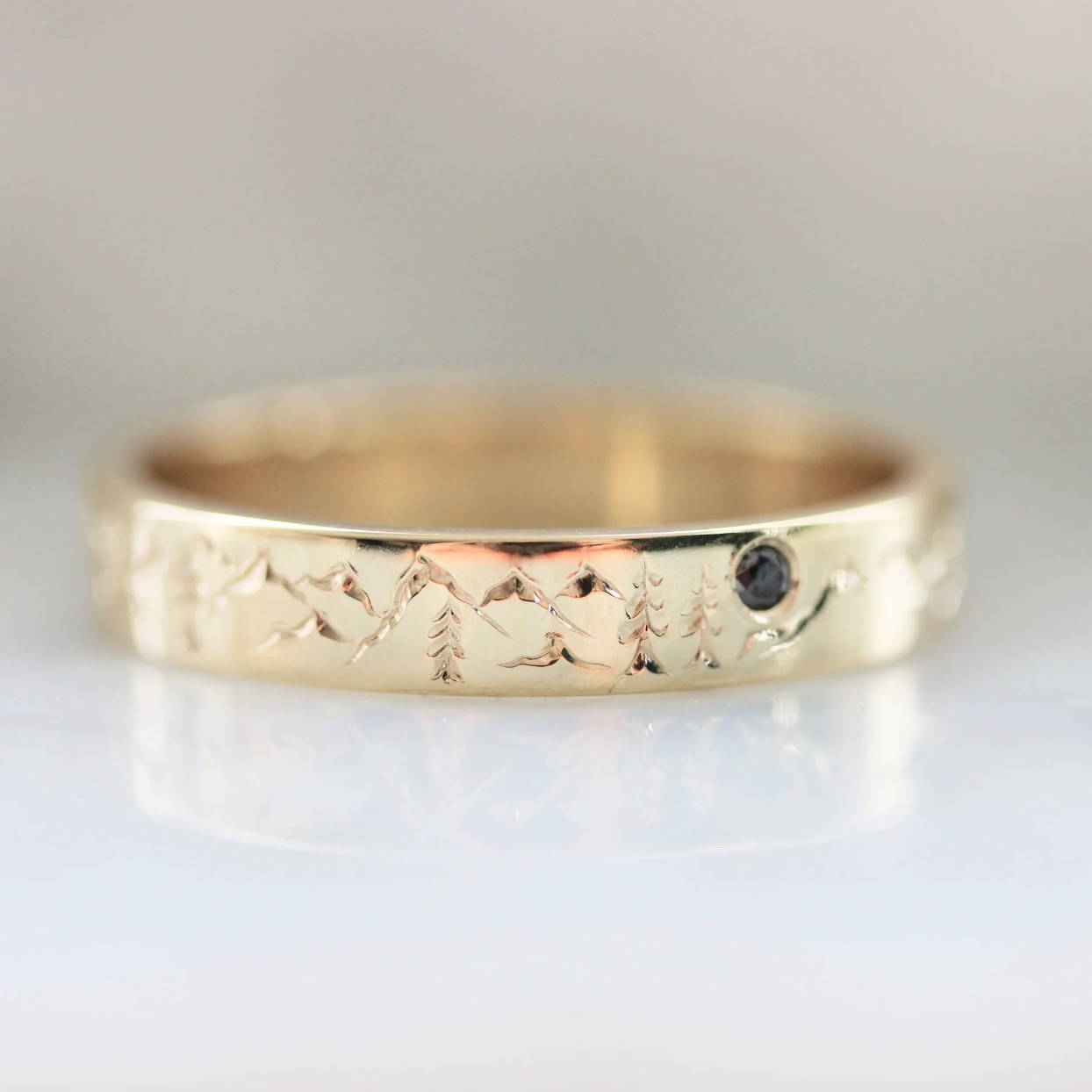 gold band with mountain and tree engraving