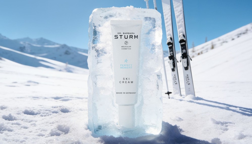 Ski gear with a frozen skincare product in a snowy mountain landscape.