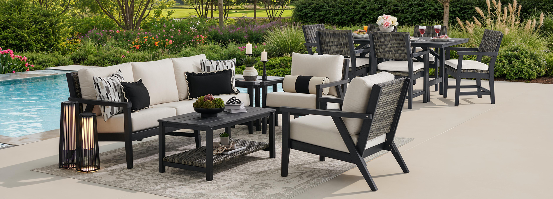 Outdoor seating area with cushions near a pool, featuring a table and chairs.