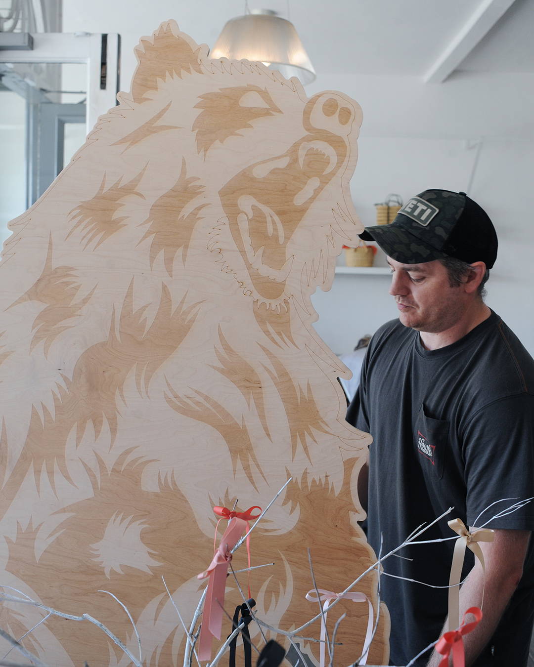Rowan from Yeti, installing the giant bear in the project space.