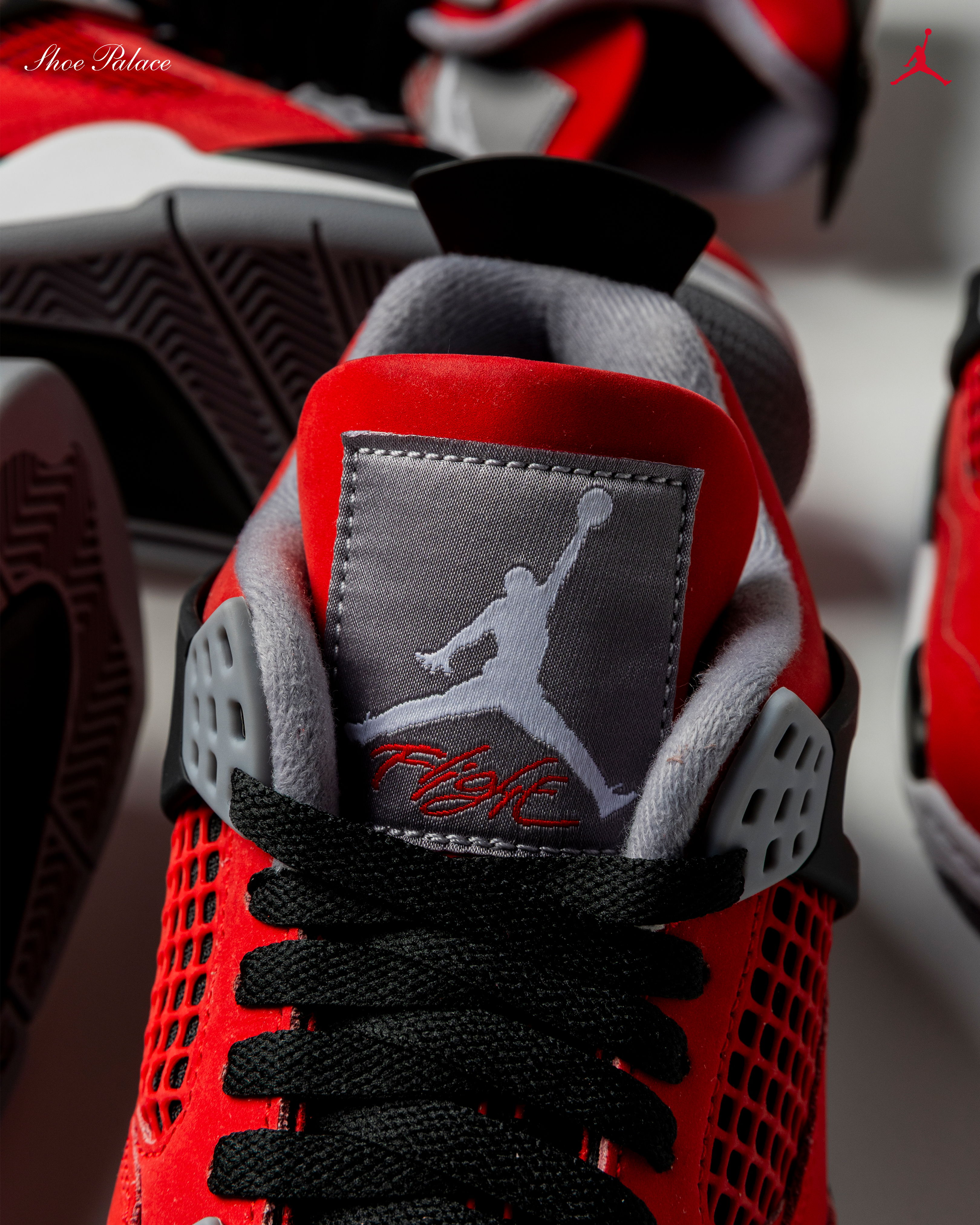 Red and black sneakers with a Jumpman logo on the tongue.