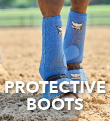 Protective boots worn on legs in a sandy environment.