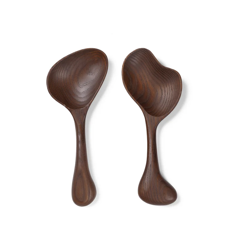 Two wooden serving spoons with unique shapes and dark finishes.
