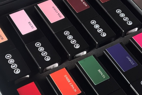 A collection of colorful lipstick tubes arranged in a box.