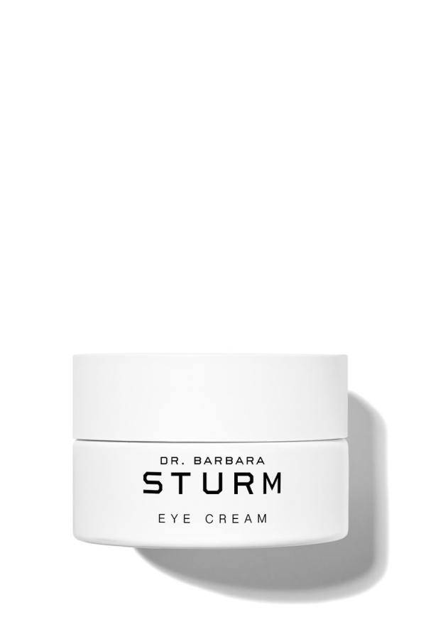 White jar of Dr. Barbara Sturm eye cream on a plain background.