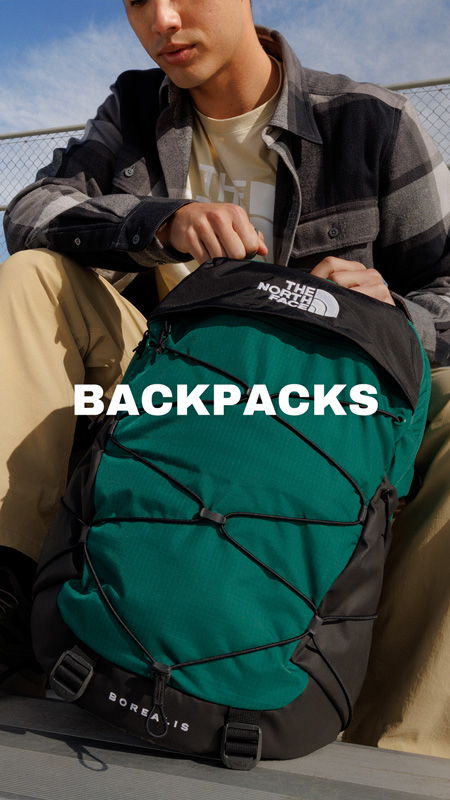 Person with a green and black backpack, text overlay says 