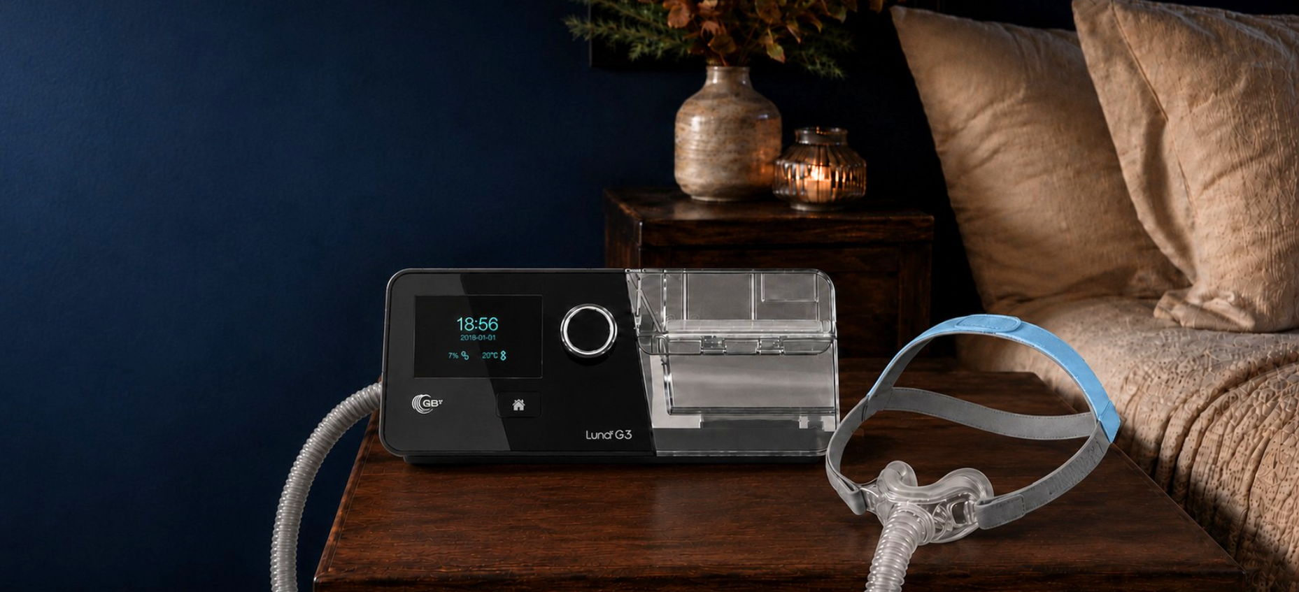 Medical device on a bedside table with a hose and mask.