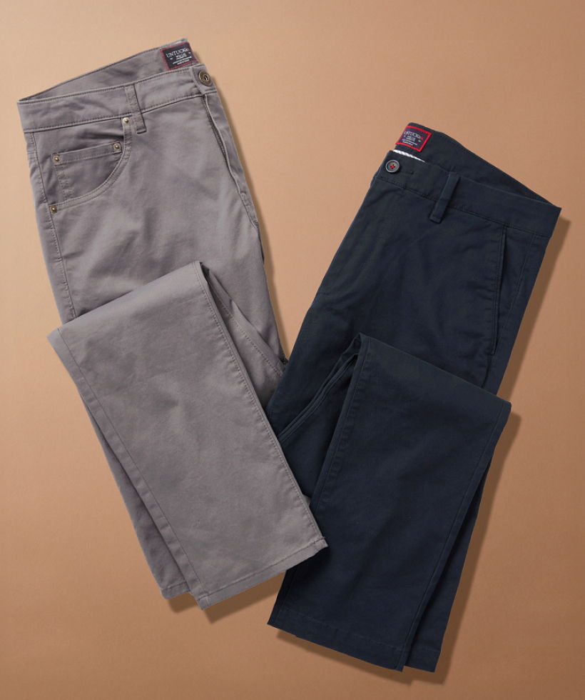 Two pairs of pants, one grey and one navy, on a beige background.
