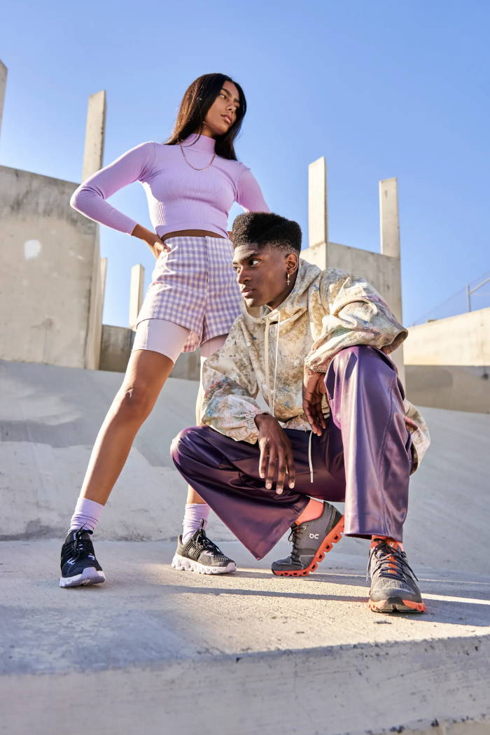 male and female model posing in on running shoes