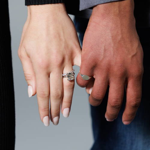 women and man holding hands featuring lab grown diamond engagement ring and signet pinky ring by MiaDonna