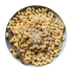 cavatappi pasta in a cheesy sauce topped with shredded cheese