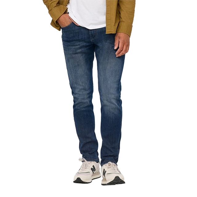 Person wearing a brown jacket, white shirt, blue jeans, and sneakers.