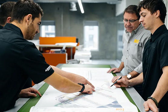 hoj-workers-reviewing-warehouse-plans