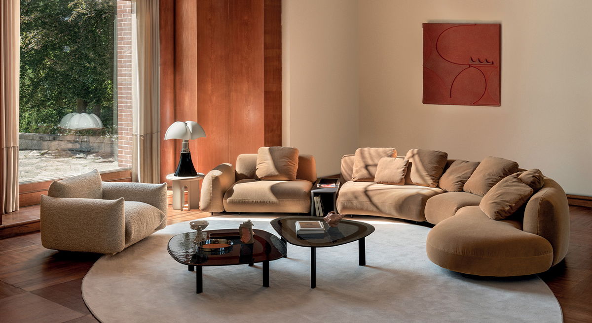 Cozy living room with beige furniture and a round rug.