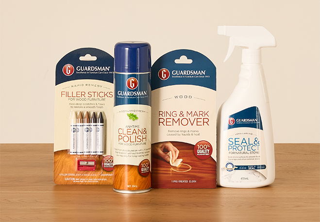 Three cleaning product bottles on a wooden surface.