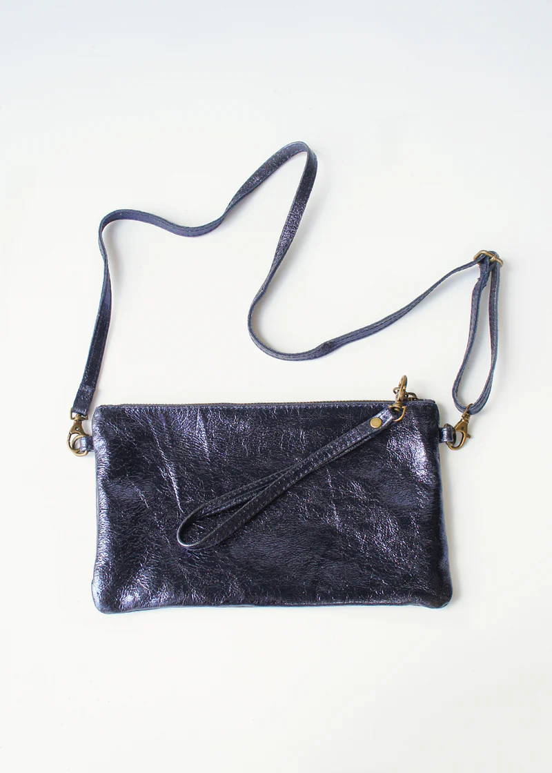 A dark blue metallic clutch bag with a removeable strap and write strap