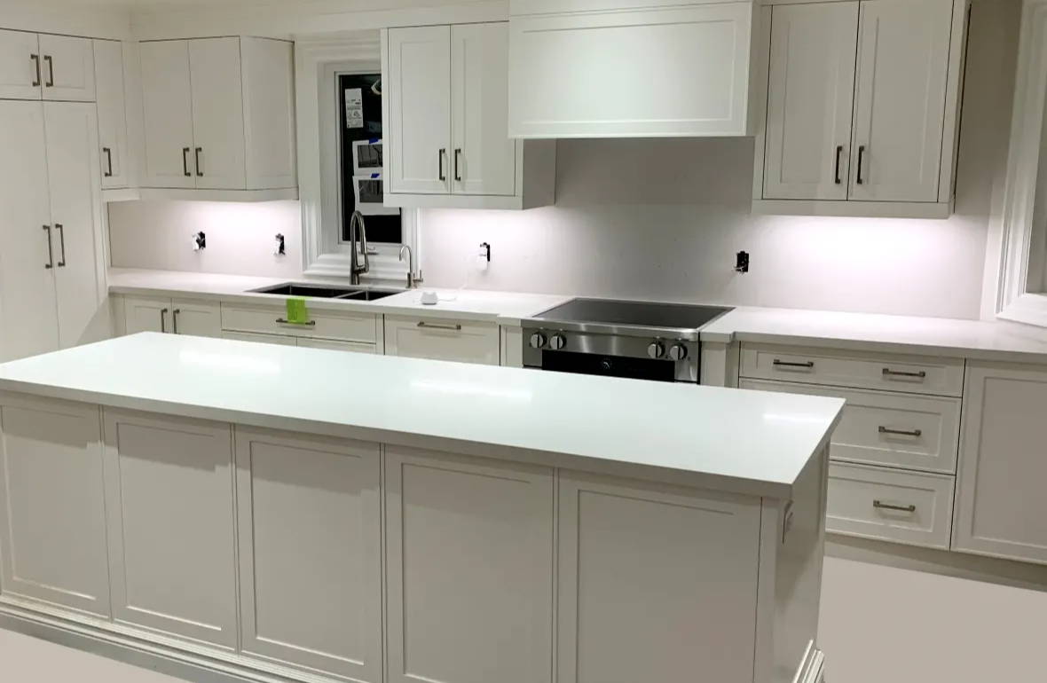 Kitchen with island and cool white under cabinet lighting using LED strip lights