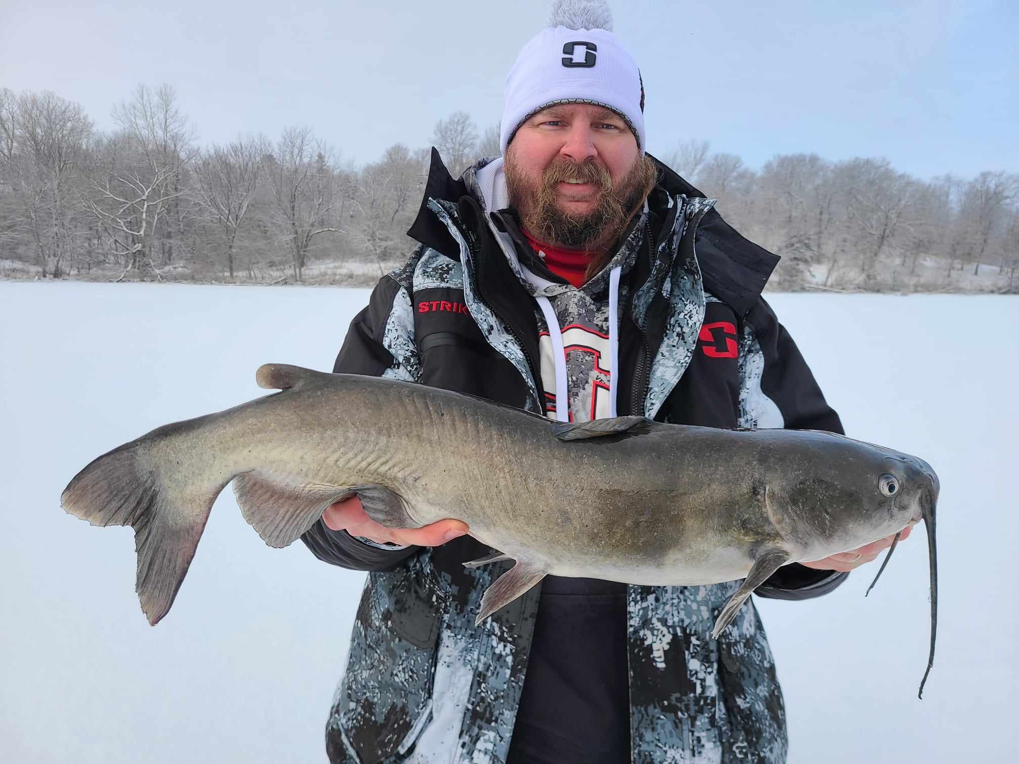 Pro-Staffer Troy Hansen holding an impressive channel cat caught through the ice.