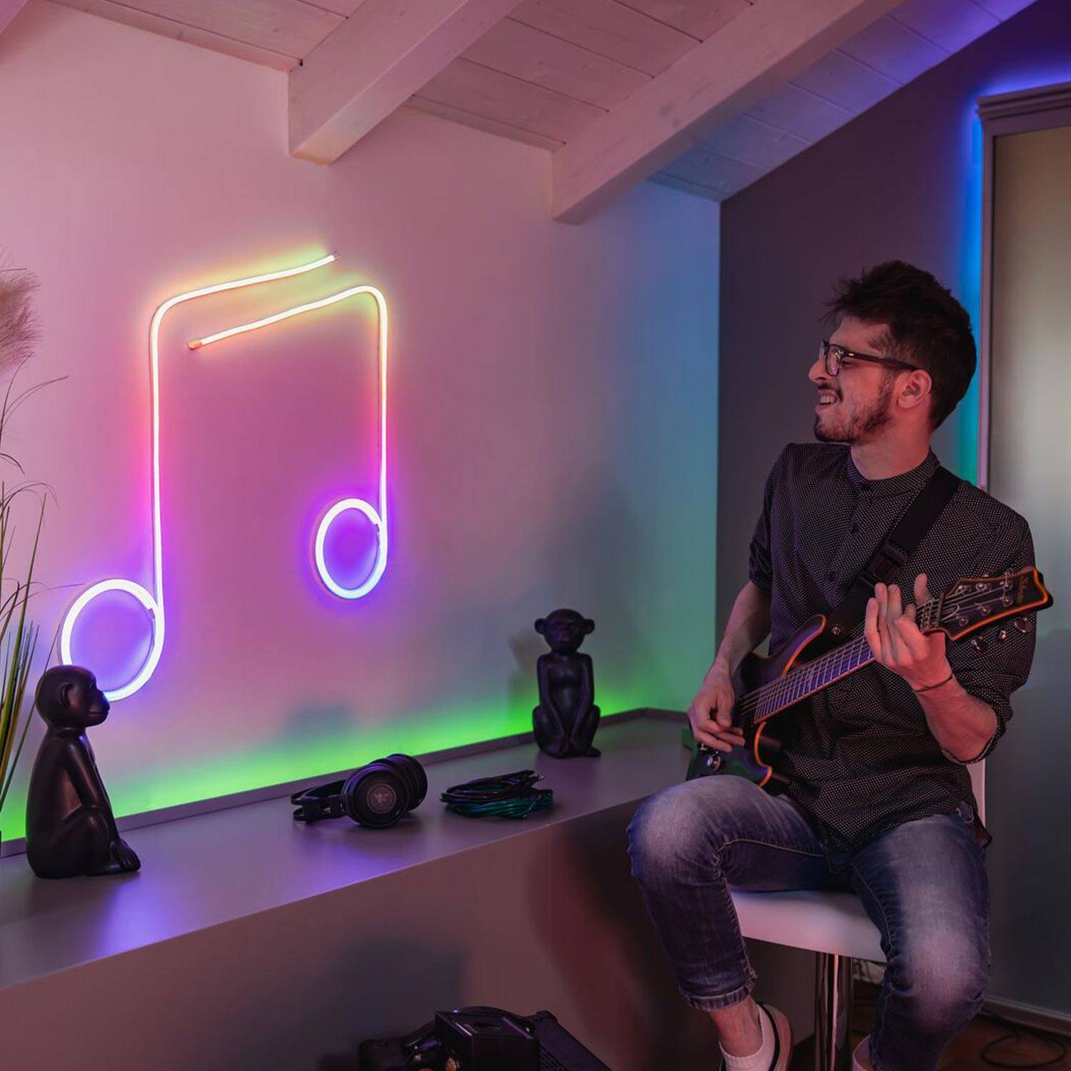 Twinkly Flex in the shape of a music note with a musician next to it.