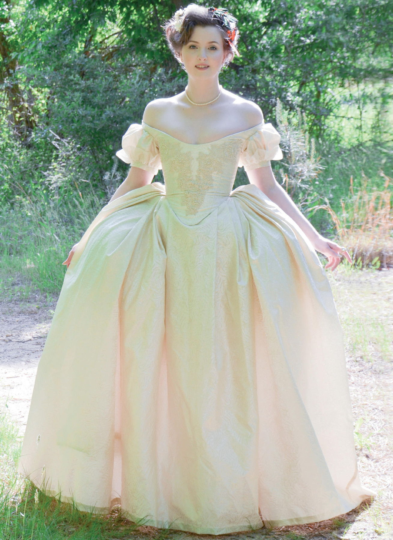 A person in a vintage dress standing outdoors.
