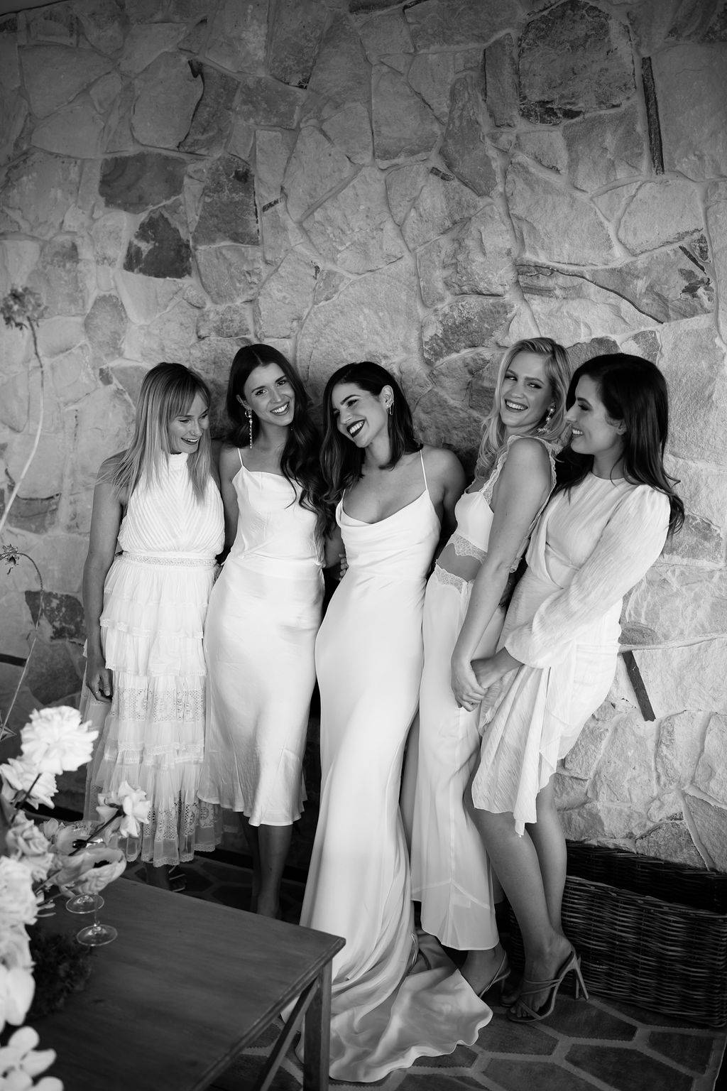 Bride with her bridesmaids all wearing white dresses