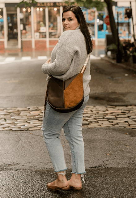 woman wearing brown crossbody bag