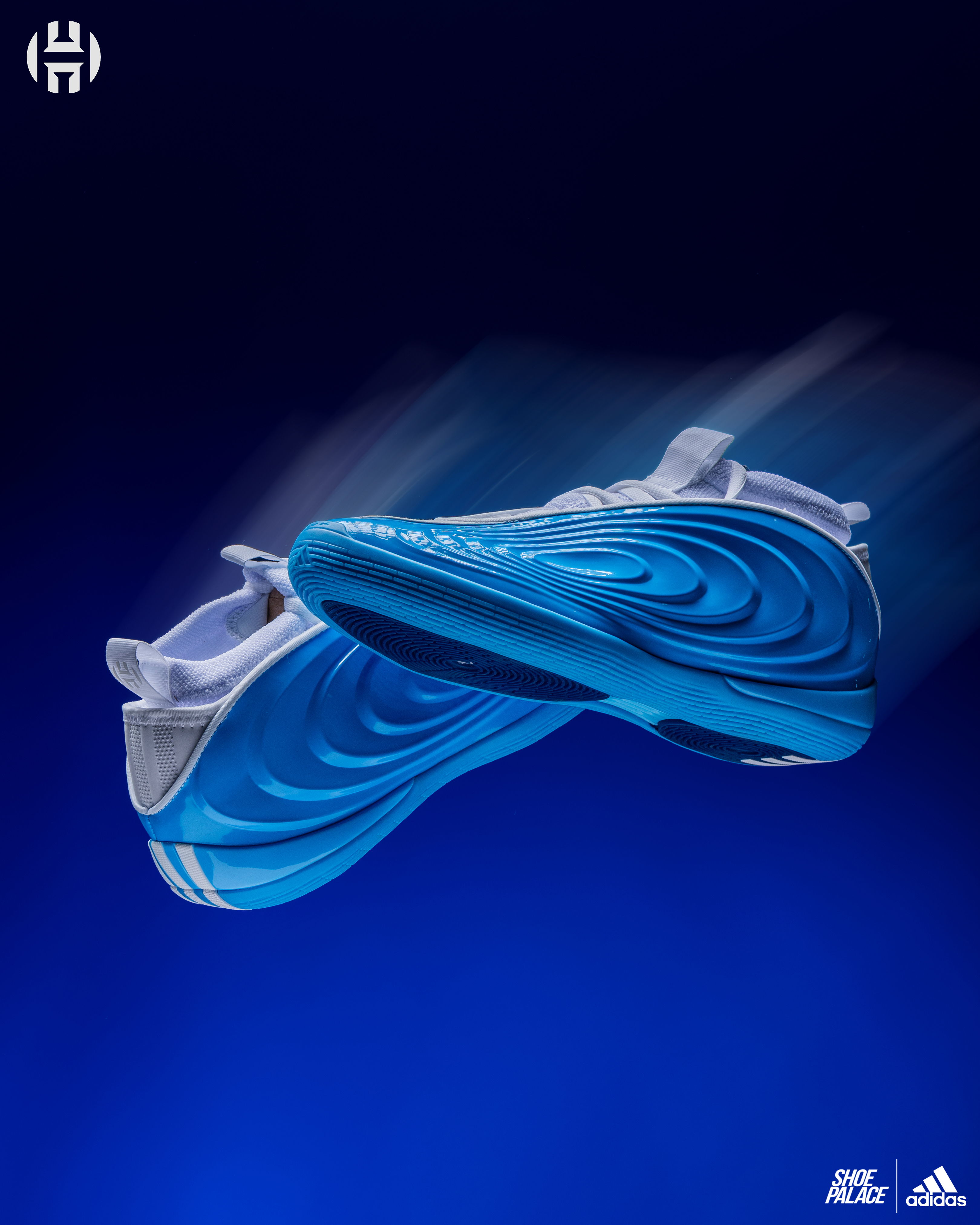 Blue athletic shoes with a dynamic design against a dark background.