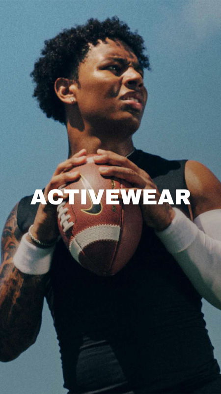 Person holding a football, wearing activewear with 