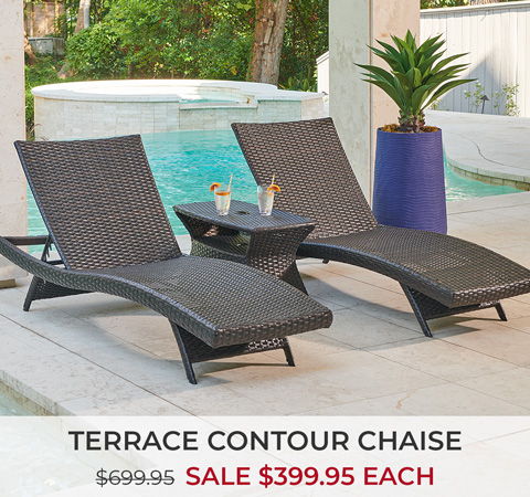 Two lounge chairs by a pool with a small table and drinks.