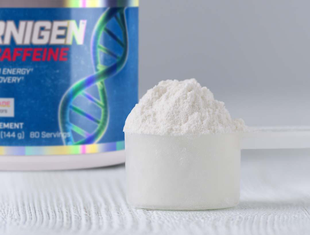 Scoop of Carnigen Plus in front of can of Carnigen Plus